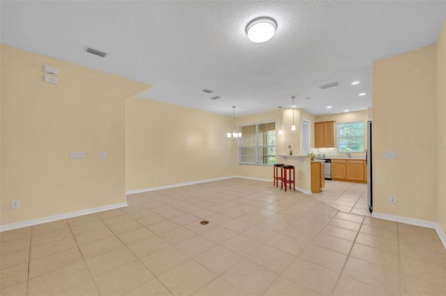 1534 Barking Deer Cv, Casselberry, FL 32707 - unfurnished living room featuring light tile patterned floors, a textured ceiling, recessed lighting, and a chandelier