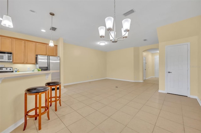 1534 Barking Deer Cv, Casselberry, FL 32707 - kitchen with white microwave, arched walkways, a breakfast bar area, stove, and light tile patterned floors
