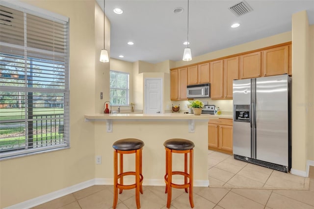 1534 Barking Deer Cv, Casselberry, FL 32707 - kitchen featuring appliances with stainless steel finishes, a kitchen breakfast bar, light countertops, light tile patterned floors, and recessed lighting