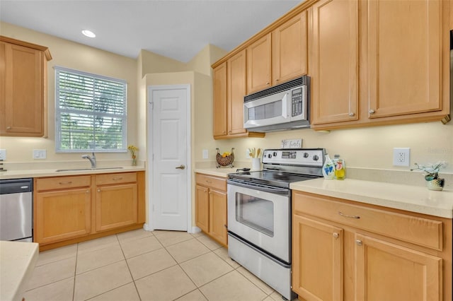 1534 Barking Deer Cv, Casselberry, FL 32707 - kitchen with appliances with stainless steel finishes, light brown cabinetry, light countertops, light tile patterned floors, and recessed lighting