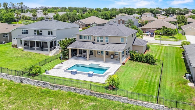 16412 Good Hearth Blvd, Clermont, FL 34711 - back of property featuring a sunroom, a residential view, a shingled roof, and a fenced backyard