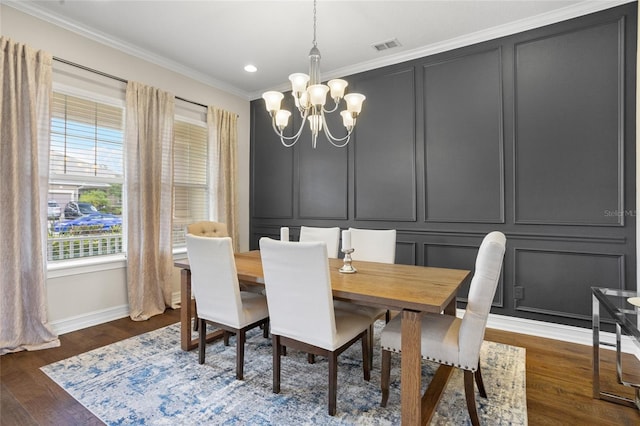 16412 Good Hearth Blvd, Clermont, FL 34711 - dining room with a decorative wall, a chandelier, ornamental molding, dark wood finished floors, and recessed lighting