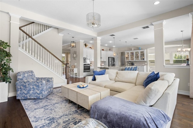 16412 Good Hearth Blvd, Clermont, FL 34711 - living room with decorative columns, stairs, dark wood finished floors, recessed lighting, and plenty of natural light