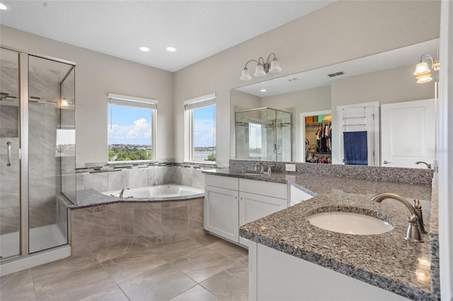 16412 Good Hearth Blvd, Clermont, FL 34711 - full bathroom featuring a shower stall, vanity, a bath, a spacious closet, and recessed lighting