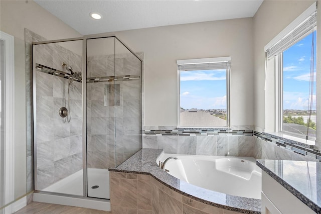 16412 Good Hearth Blvd, Clermont, FL 34711 - bathroom featuring a garden tub, a shower stall, and recessed lighting