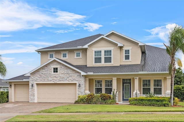 16412 Good Hearth Blvd, Clermont, FL 34711 - view of front of house featuring stucco siding, stone siding, driveway, a front lawn, and an attached garage