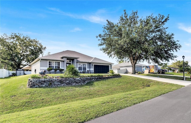 2919 Foraker Way, Kissimmee, FL 34758 - ranch-style home featuring a garage, driveway, and stucco siding
