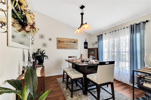 2919 Foraker Way, Kissimmee, FL 34758 - dining room with vaulted ceiling and dark wood finished floors