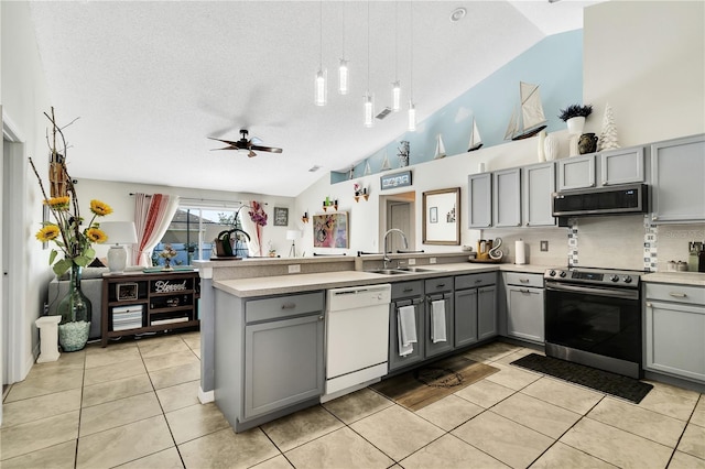 2919 Foraker Way, Kissimmee, FL 34758 - kitchen featuring gray cabinetry, stainless steel appliances, a peninsula, ceiling fan, and a textured ceiling