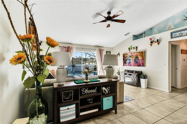 2919 Foraker Way, Kissimmee, FL 34758 - tiled living area featuring ceiling fan, a textured ceiling, and lofted ceiling