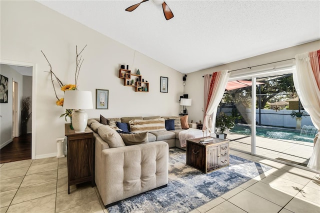 2919 Foraker Way, Kissimmee, FL 34758 - living area with a ceiling fan, light tile patterned floors, vaulted ceiling, a textured ceiling, and radiator heating unit