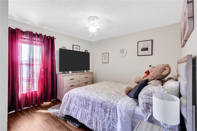 2919 Foraker Way, Kissimmee, FL 34758 - bedroom with wood finished floors, a textured ceiling, and a ceiling fan