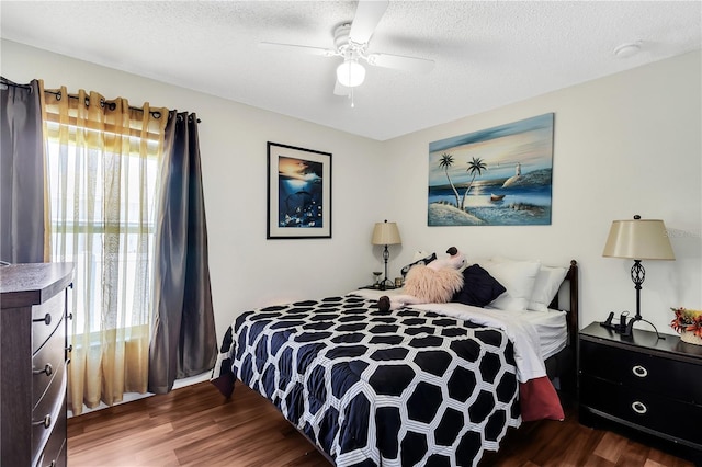 2919 Foraker Way, Kissimmee, FL 34758 - bedroom featuring wood finished floors, a textured ceiling, and a ceiling fan