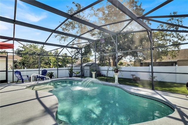 2919 Foraker Way, Kissimmee, FL 34758 - view of swimming pool featuring a patio area, a fenced backyard, a storage unit, and a lanai