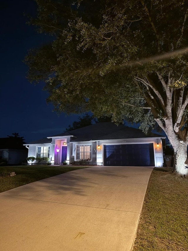 2919 Foraker Way, Kissimmee, FL 34758 - view of front facade featuring an attached garage, concrete driveway, and a lawn