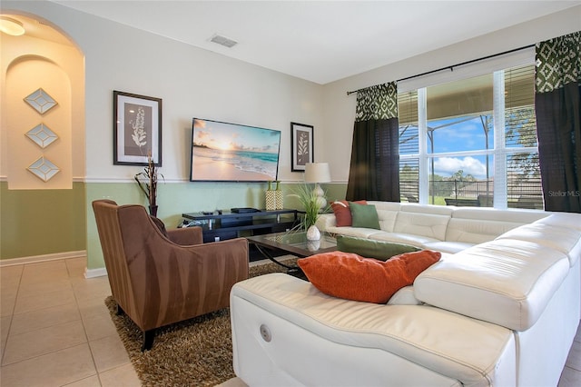 2669 Manesty Ln, Kissimmee, FL 34747 - tiled living room with arched walkways and baseboards