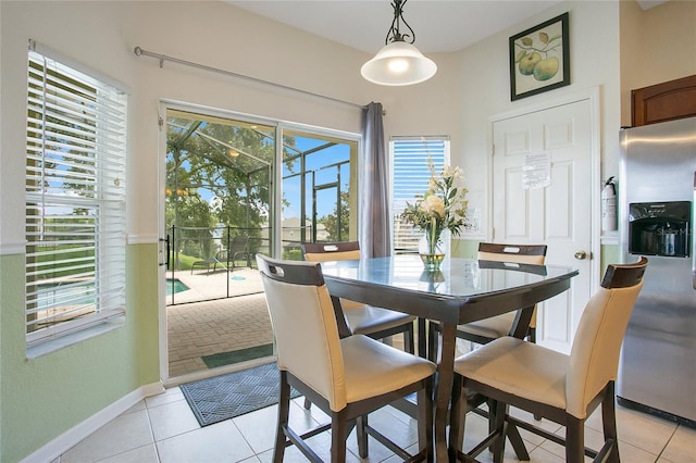 2669 Manesty Ln, Kissimmee, FL 34747 - dining area featuring light tile patterned floors and a sunroom