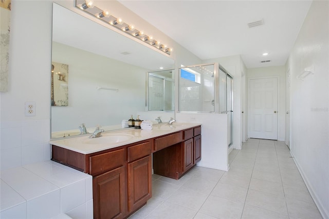 2669 Manesty Ln, Kissimmee, FL 34747 - bathroom with double vanity, a shower stall, tile patterned flooring, and recessed lighting