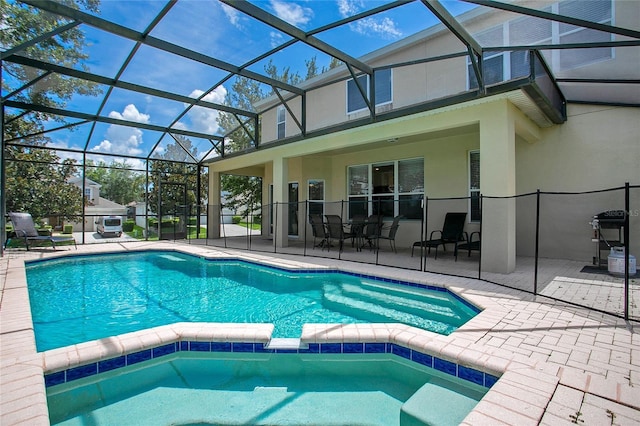 2669 Manesty Ln, Kissimmee, FL 34747 - view of pool with a patio area, a pool with connected hot tub, a grill, and a lanai