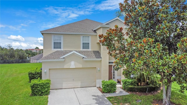 2669 Manesty Ln, Kissimmee, FL 34747 - view of front of house with a shingled roof, stucco siding, concrete driveway, a front yard, and an attached garage