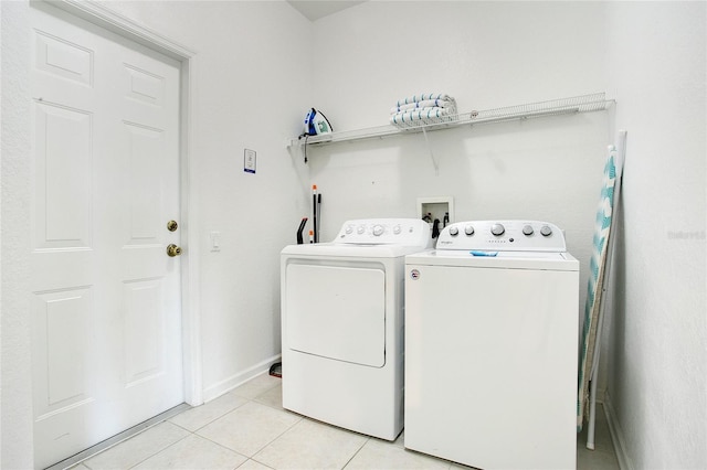 2669 Manesty Ln, Kissimmee, FL 34747 - laundry room with washer and clothes dryer and light tile patterned flooring
