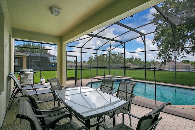 2669 Manesty Ln, Kissimmee, FL 34747 - view of swimming pool featuring a patio area, a yard, grilling area, glass enclosure, and outdoor dining space