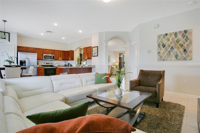 2669 Manesty Ln, Kissimmee, FL 34747 - living area with arched walkways, light tile patterned floors, recessed lighting, and decorative columns