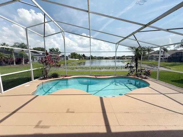 swimming pool with a patio area, a water view, a yard, and glass enclosure