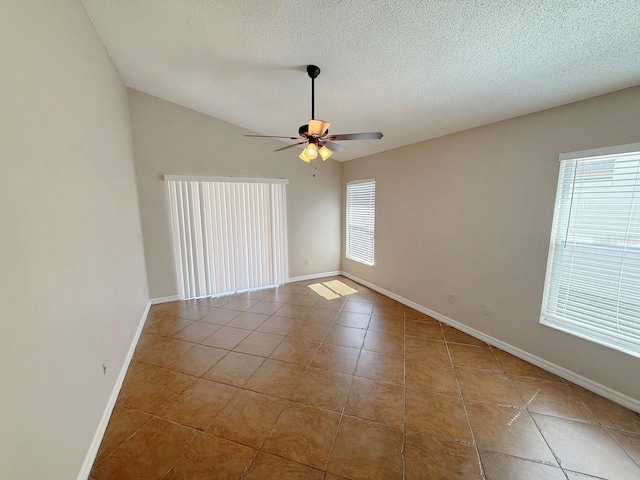 unfurnished room featuring tile patterned flooring, a ceiling fan, and a textured ceiling