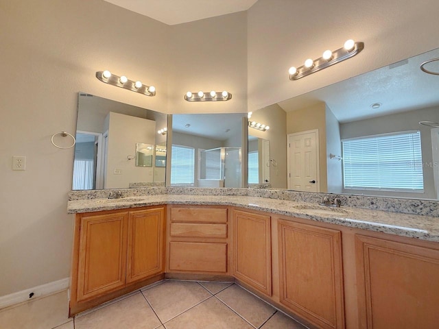 full bathroom with a stall shower, tile patterned floors, and double vanity