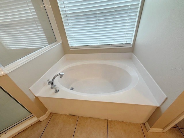 full bathroom with a bath, tile patterned floors, and healthy amount of natural light
