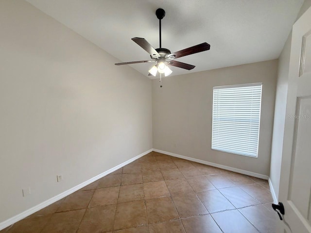 spare room with a ceiling fan and tile patterned flooring