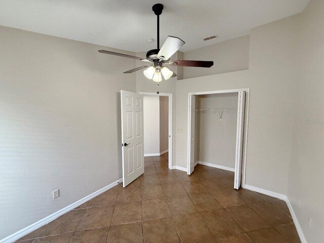 unfurnished bedroom with a closet, ceiling fan, and tile patterned flooring