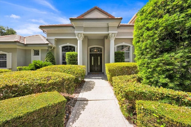307 Running Wind Ln, Maitland, FL 32751 - entrance to property featuring a tile roof and stucco siding