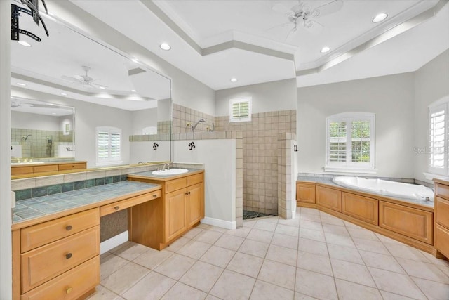 307 Running Wind Ln, Maitland, FL 32751 - bathroom featuring ceiling fan, a tray ceiling, a walk in shower, a bath, and tile patterned flooring
