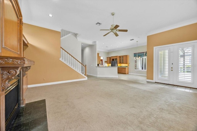 307 Running Wind Ln, Maitland, FL 32751 - unfurnished living room with light colored carpet, a ceiling fan, a fireplace, stairs, and crown molding