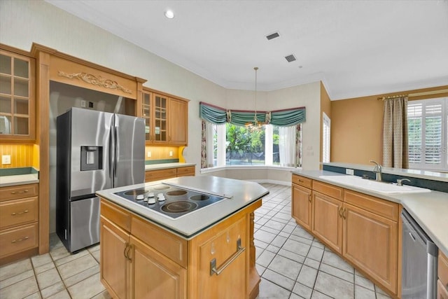 307 Running Wind Ln, Maitland, FL 32751 - kitchen with stainless steel appliances, light tile patterned flooring, plenty of natural light, a center island, and crown molding
