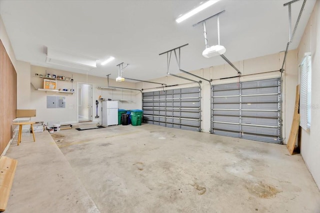 307 Running Wind Ln, Maitland, FL 32751 - garage featuring a garage door opener, freestanding refrigerator, and electric panel