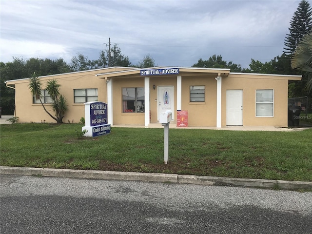 10 S Semoran Blvd S, Orlando, FL 32822 - view of front of home featuring stucco siding and a front yard