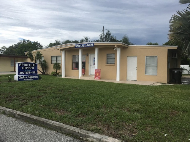 10 S Semoran Blvd S, Orlando, FL 32822 - view of front of house with stucco siding and a front lawn