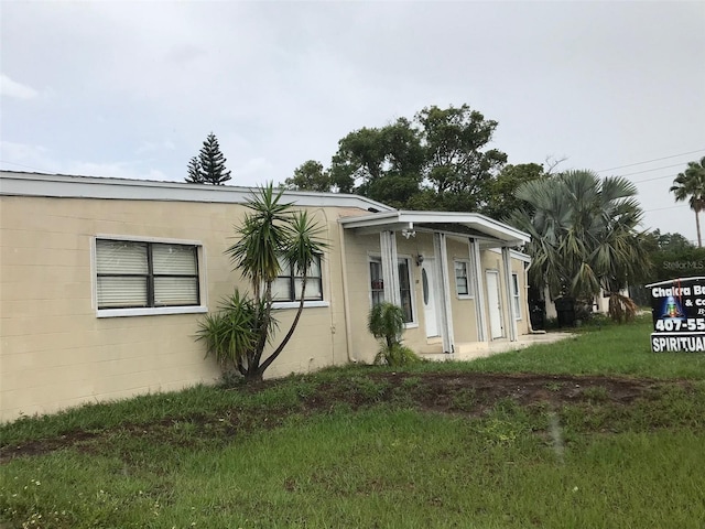 10 S Semoran Blvd S, Orlando, FL 32822 - view of front of home with concrete block siding and a front lawn