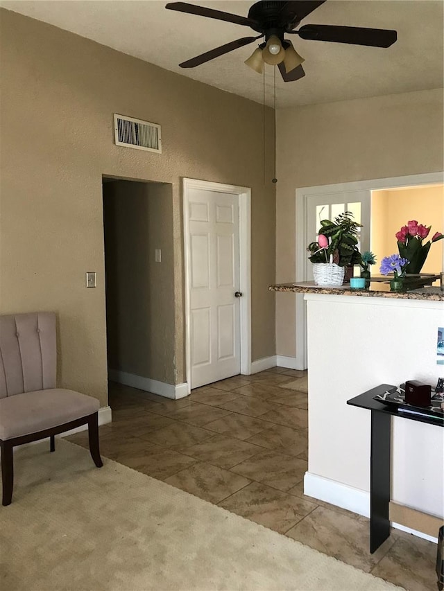 10 S Semoran Blvd S, Orlando, FL 32822 - living area featuring ceiling fan and baseboards