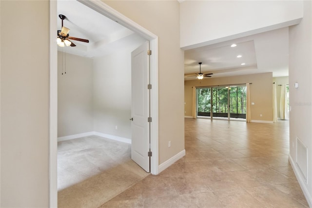 207 Spalding Way, Deland, FL 32724 - empty room with a raised ceiling, ceiling fan, recessed lighting, and light tile patterned flooring