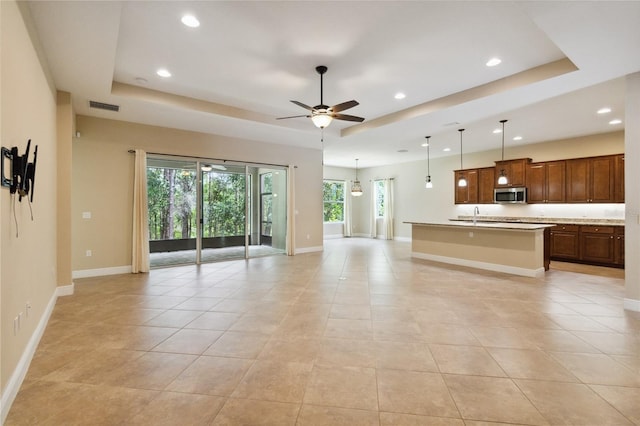 207 Spalding Way, Deland, FL 32724 - unfurnished living room featuring a tray ceiling, recessed lighting, a ceiling fan, and light tile patterned floors