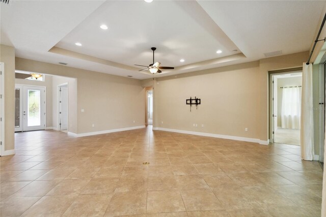207 Spalding Way, Deland, FL 32724 - empty room featuring a tray ceiling, recessed lighting, a ceiling fan, and light tile patterned floors