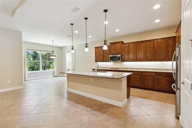 207 Spalding Way, Deland, FL 32724 - kitchen with appliances with stainless steel finishes, recessed lighting, light stone countertops, a center island with sink, and light tile patterned floors