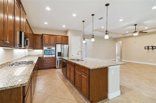 207 Spalding Way, Deland, FL 32724 - kitchen with stainless steel appliances, light tile patterned floors, recessed lighting, an island with sink, and light stone counters