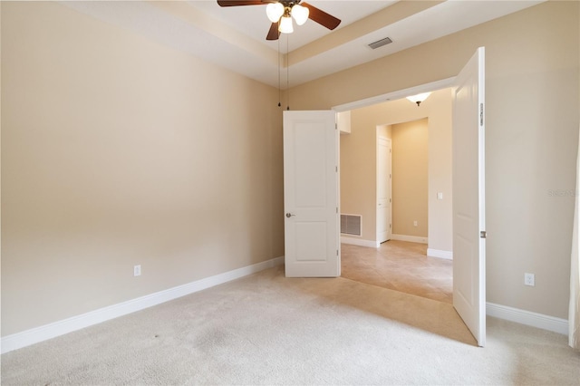 207 Spalding Way, Deland, FL 32724 - unfurnished bedroom featuring light carpet, a ceiling fan, and a raised ceiling