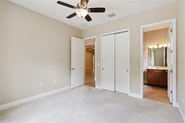 207 Spalding Way, Deland, FL 32724 - unfurnished bedroom with light carpet, a closet, ensuite bath, and a ceiling fan