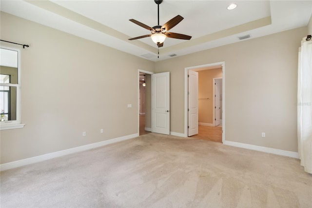 207 Spalding Way, Deland, FL 32724 - unfurnished bedroom with light colored carpet, a tray ceiling, recessed lighting, and ceiling fan